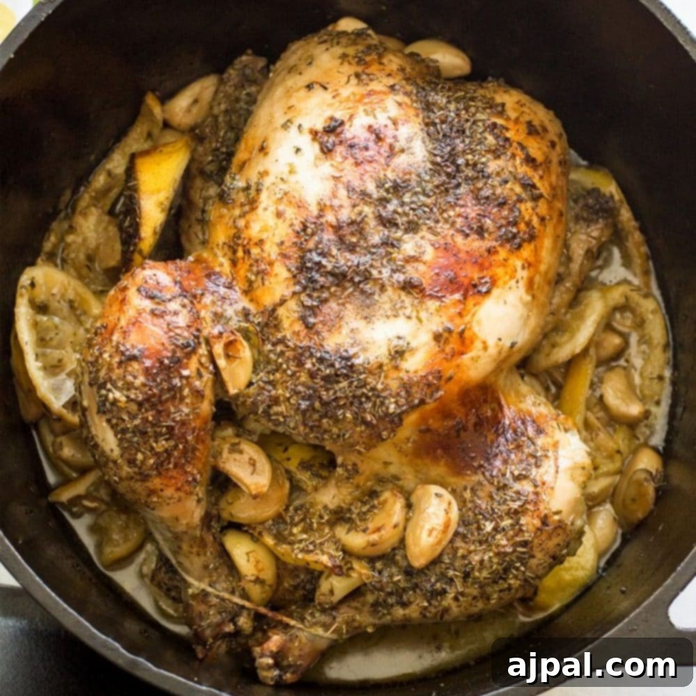 Close-up of the crispy skin and tender meat of a Dutch oven lemon garlic chicken, ready to be served.