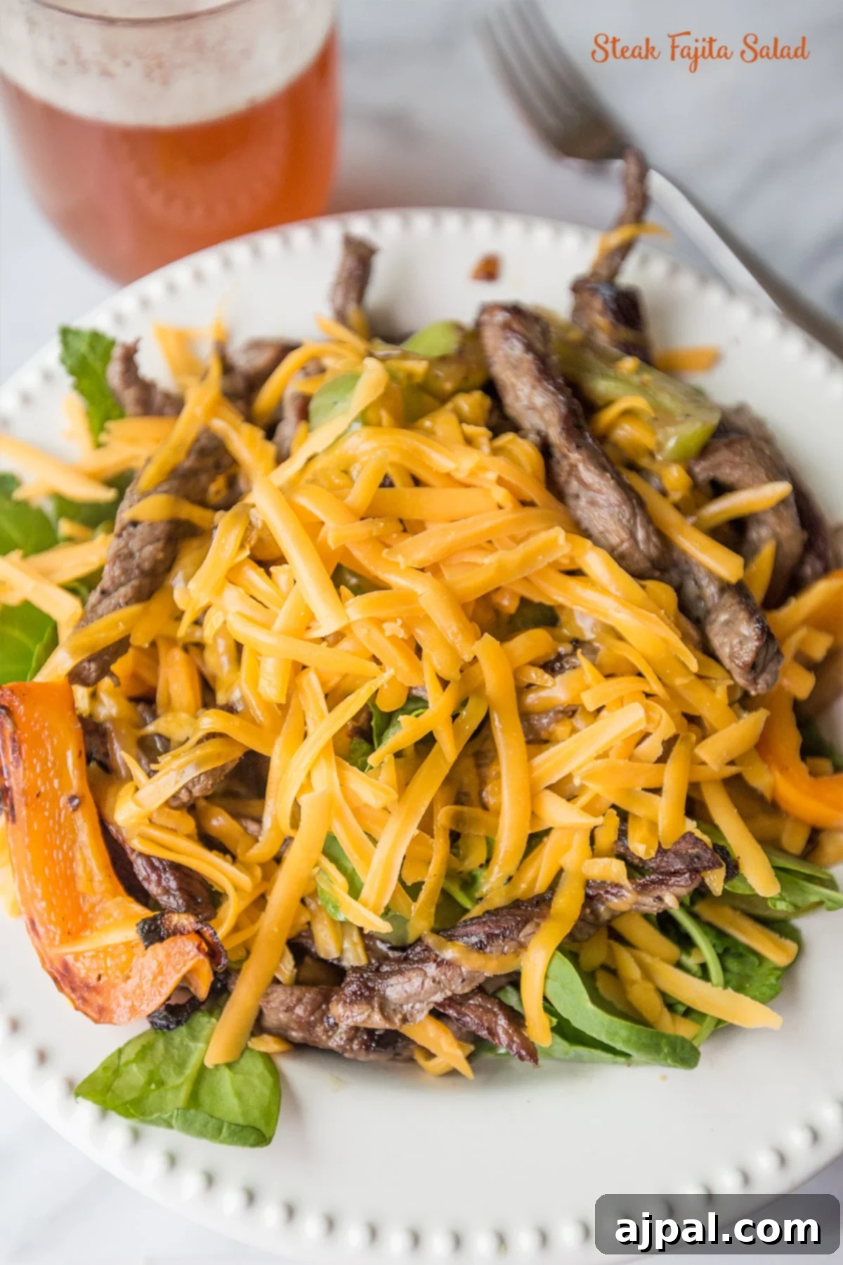 Sizzling Fajita Steak Salad 2 salad with grilled peppers, steak, and cheese