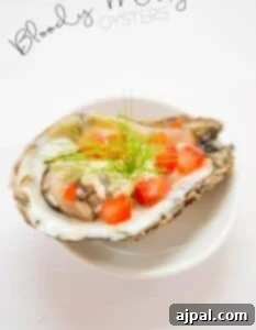 Bloody Mary oysters garnished with fennel and dill.