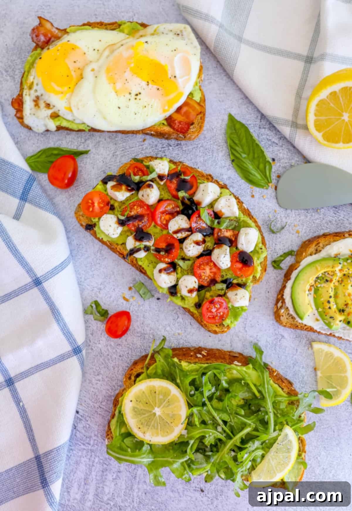 Smashed Avocado Toast 2 Four slices of toast with different toppings, including creamy avocado, poached eggs, fresh tomatoes, and savory seasoning.
