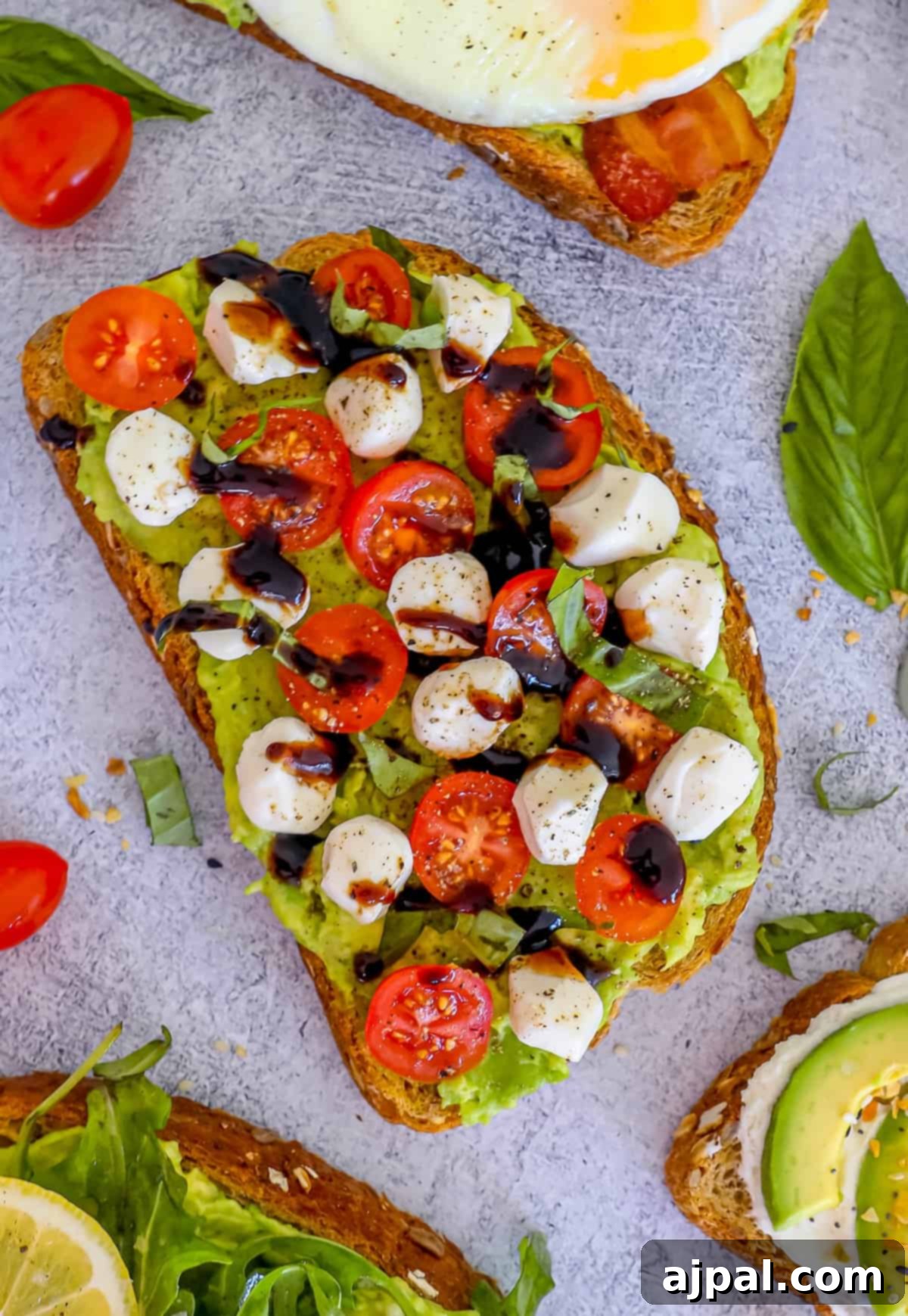 Smashed Avocado Toast 7 A perfectly arranged toast with a fried egg, juicy cherry tomatoes, and creamy avocado, ready to be enjoyed.
