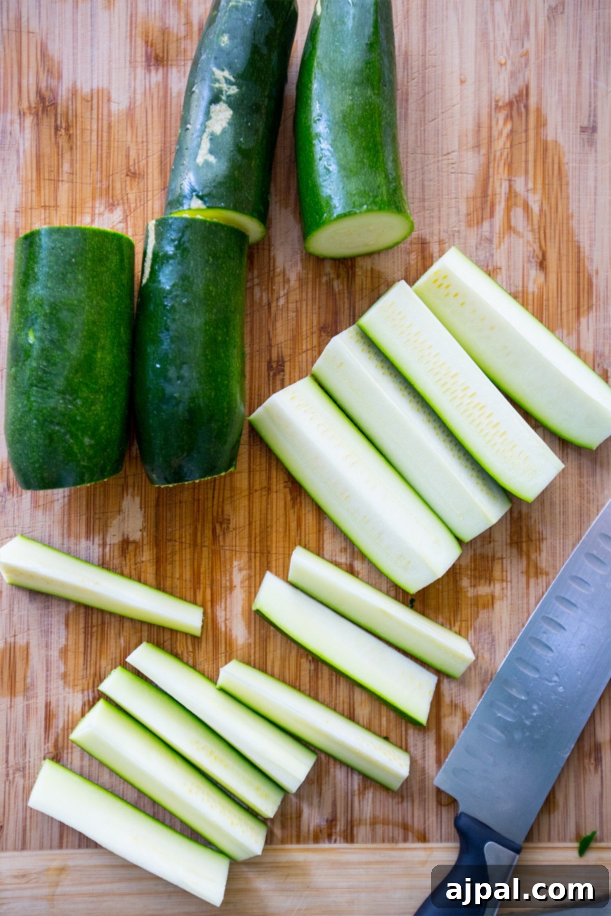 Keto Garlic Parm Zucchini Fries 3 Fresh zucchini slices seasoned with Parmesan and garlic, ready for baking