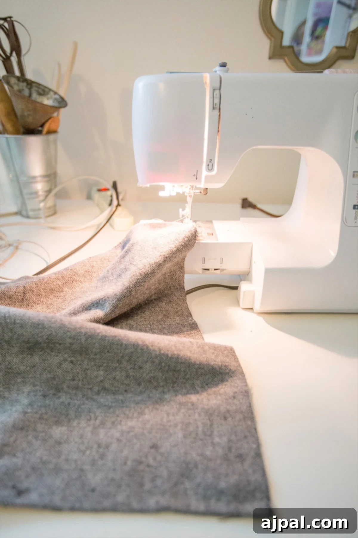 Whip Up a Lace Infinity Scarf in 15 Minutes 4 Close-up of a sewing machine stitching two pieces of fabric together to form a long strip for an infinity scarf, showing the initial seam for a beginner-friendly project.