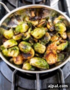 Pan fried brussels sprouts with ghee on the stove.