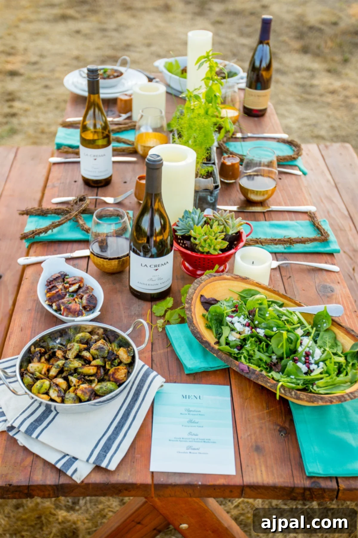 Table set up with wine, Brussels sprouts, and salad for a fall harvest meal.