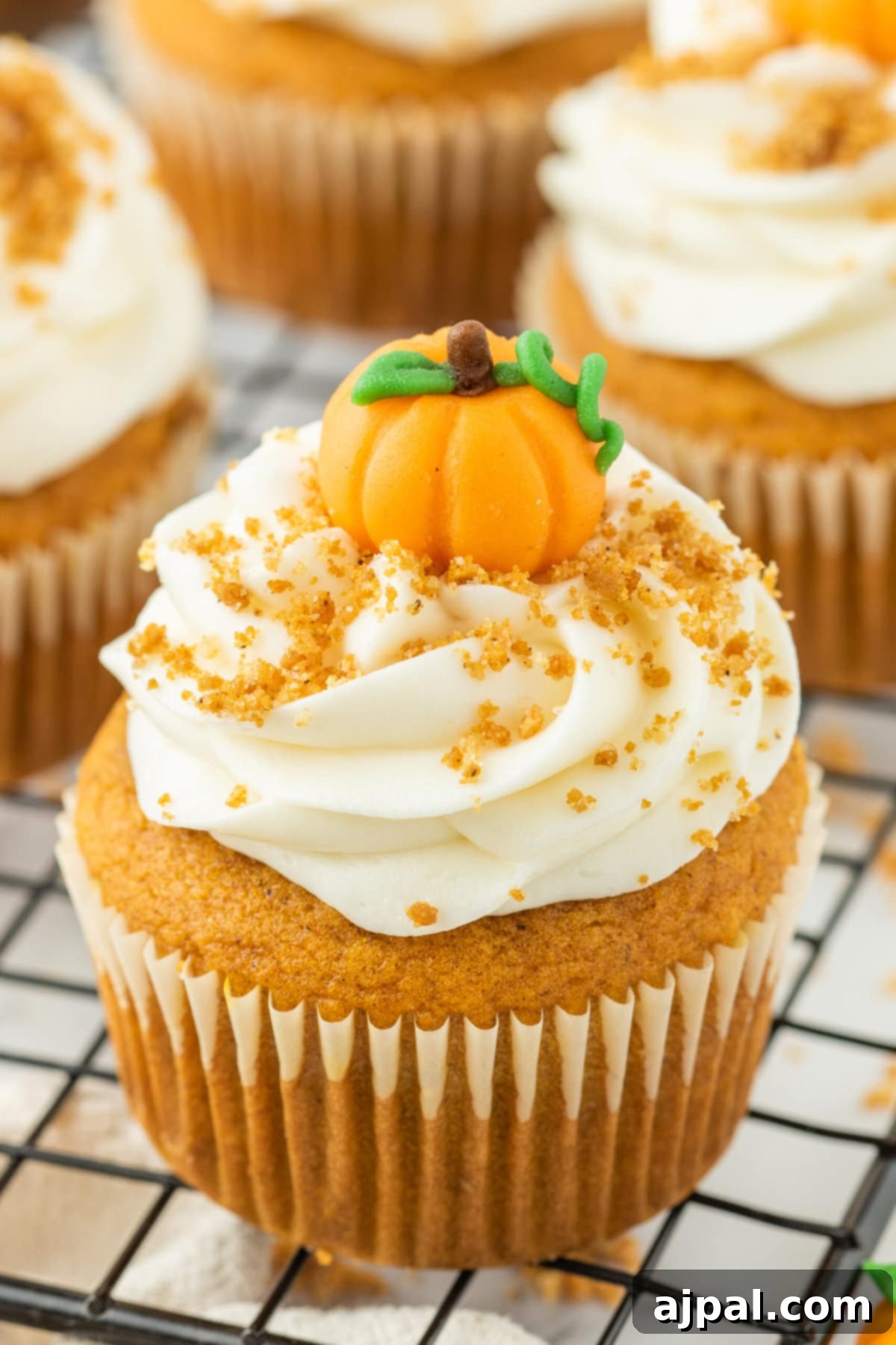 Spooktacular Halloween Treats You Need to Try 14 Easy pumpkin cupcakes on a cooling rack.