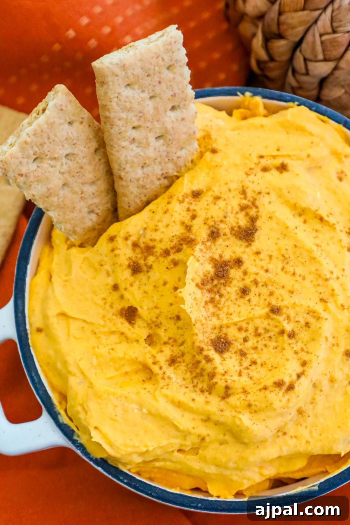 Spooktacular Halloween Treats You Need to Try 25 A bowl of pumpkin pie fluff topped with crackers.