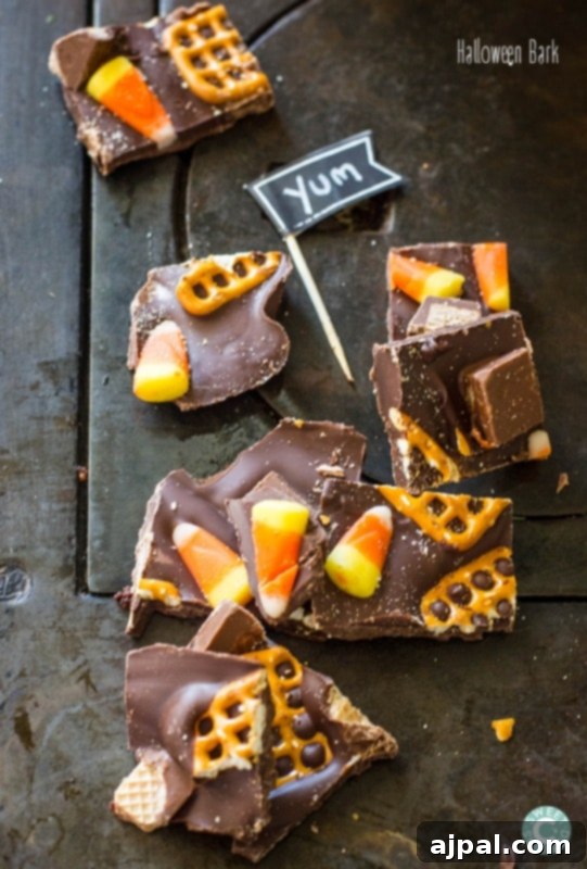 Spooktacular Halloween Treats You Need to Try 27 A table covered in Halloween Bark, a mixture of chocolate and candy bars.