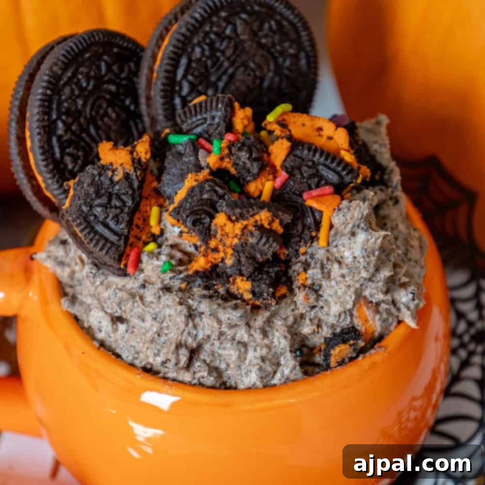 Spooktacular Halloween Treats You Need to Try 4 Halloween oreo milkshake in a mug with pumpkins and oreos.