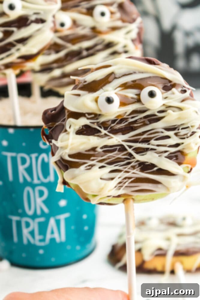 Spooktacular Halloween Treats You Need to Try 5 picture of caramel apple mummies in a blue trick or treat bowl