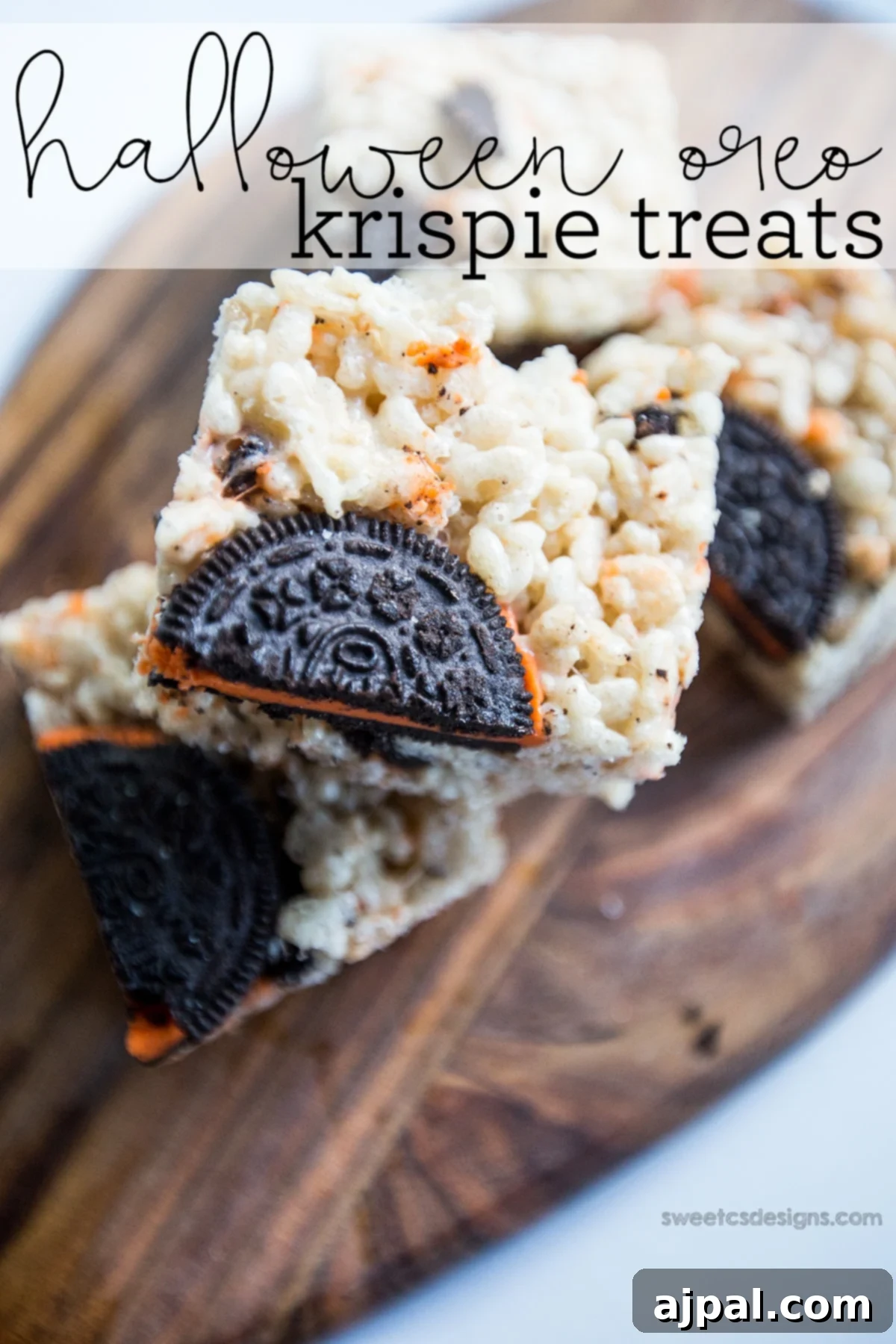 Delicious Halloween Oreo Krispie Treats featuring crushed Oreos and crispy cereal, presented on a rustic wooden cutting board.