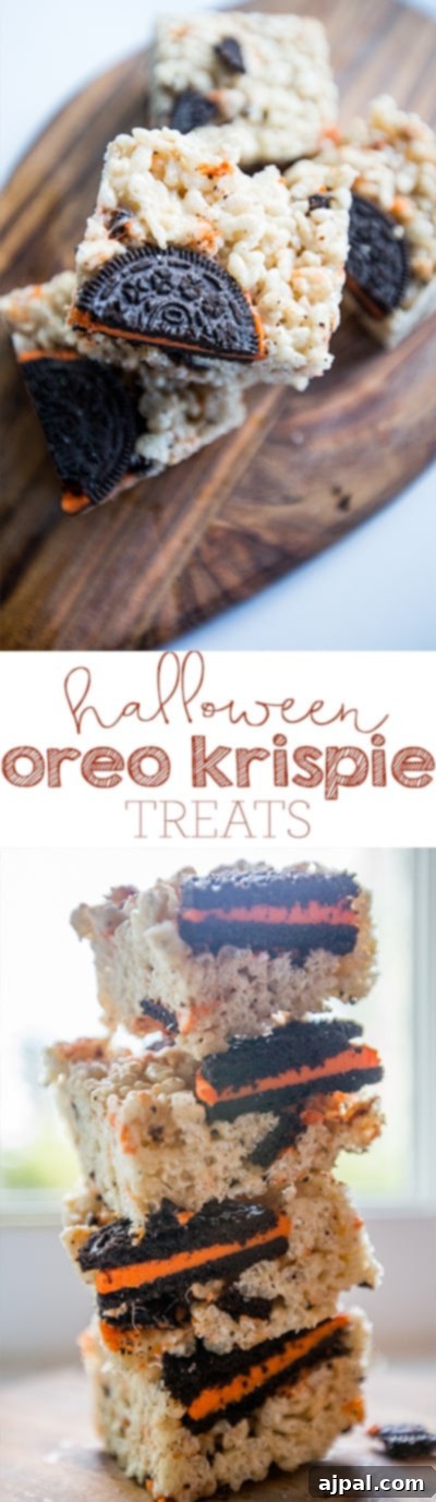 Stack of Halloween Oreo Krispie Treats, showing the delicious layers and spooky colors, on a wooden cutting board.