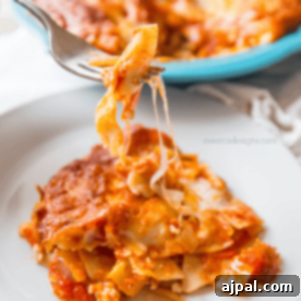 A fork is being used to pick up a piece of lasagna casserole, showcasing its delightful layers.