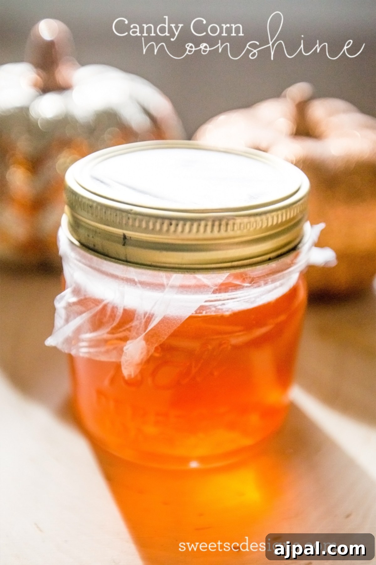 Candy Corn Elixir 4 A close-up of a jar of candy corn moonshine, perfect for fall drinks and Halloween celebrations.