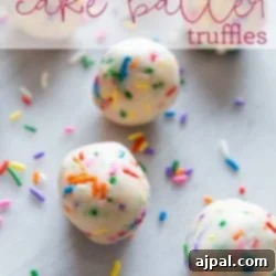A vibrant image of delicious no-bake cake batter truffles, generously covered in rainbow sprinkles.