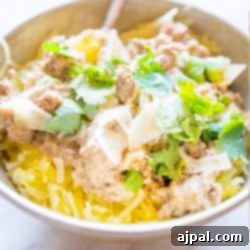 squash in a bowl with beef sauce and cheese on it.