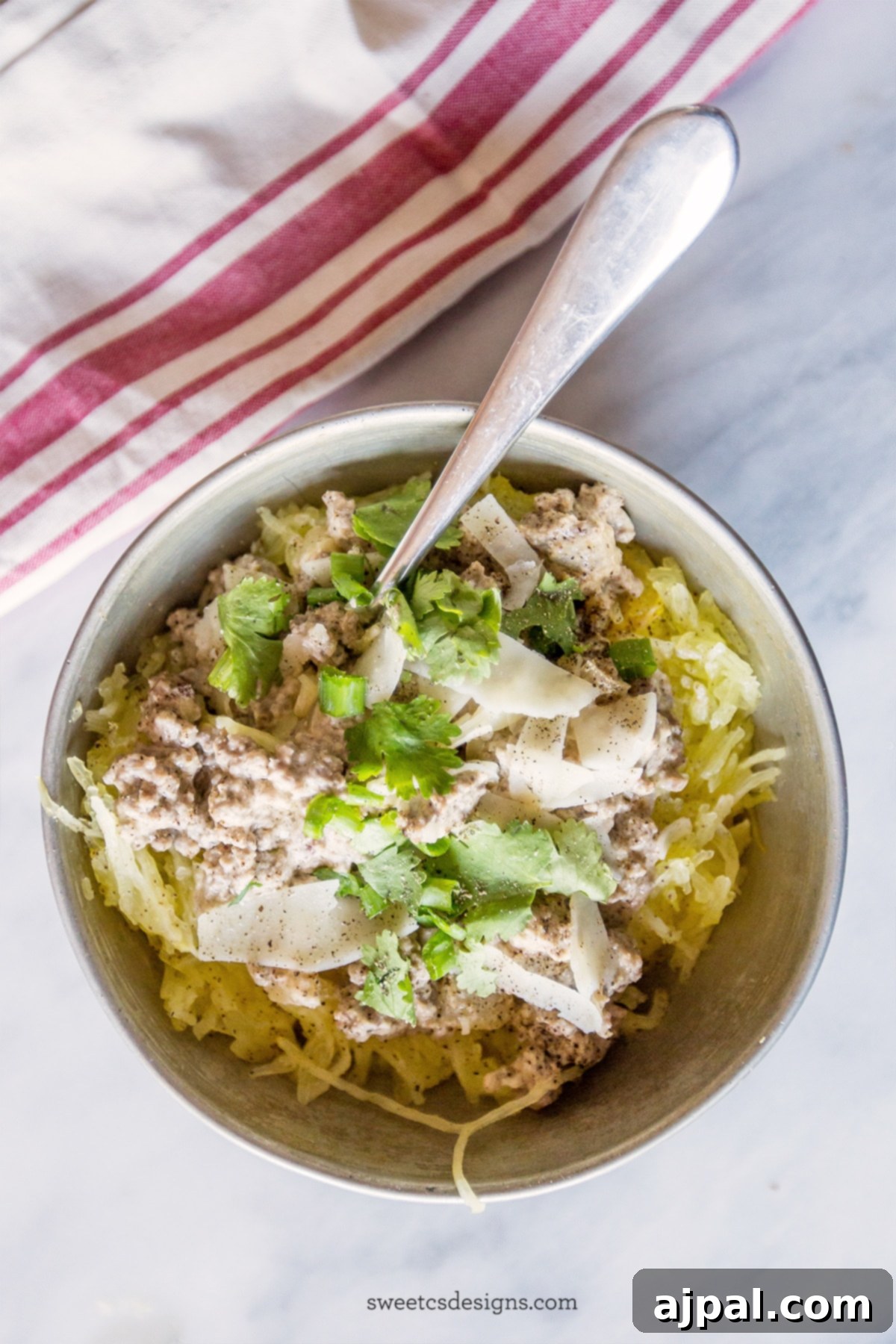 bowl of spaghetti squash with beef stroganoff, parmesan cheese and green onions. 