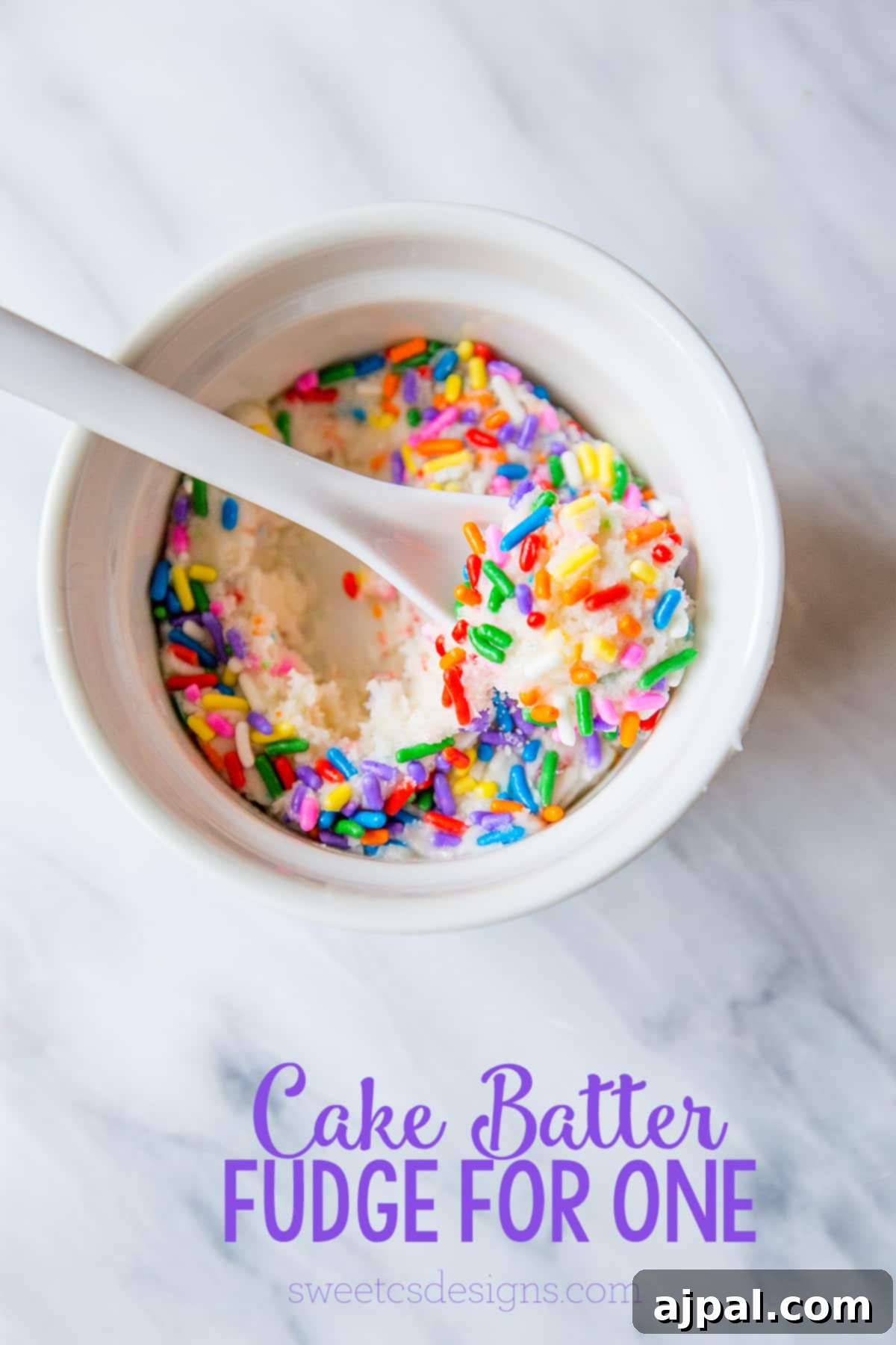 A bowl of white fudge, generously topped with colorful sprinkles, showcasing the delightful simplicity of single-serve cake batter fudge.