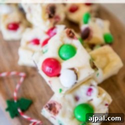 A festive block of Christmas candy fudge, beautifully adorned with colorful candies.