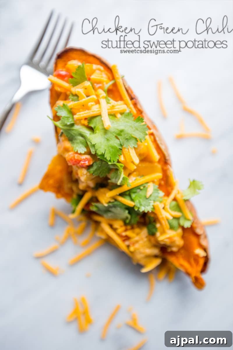 Southwestern Chicken Stuffed Sweet Potatoes 2 Delicious chicken green chili stuffed sweet potato topped with melted cheese and fresh cilantro, ready to eat.
