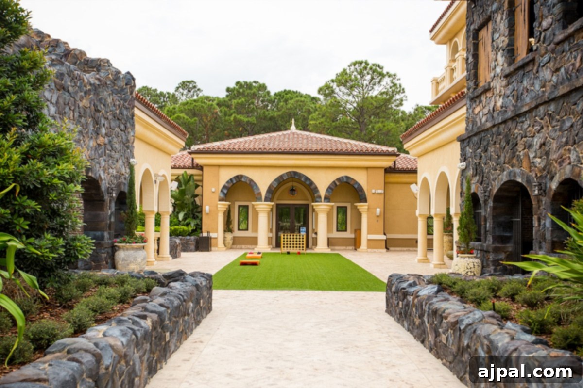 Four Seasons Orlando at Disney World A Magical Getaway 10 A stone house with a green lawn, part of the outdoor game area and kids camp at Four Seasons Orlando at Disney World.