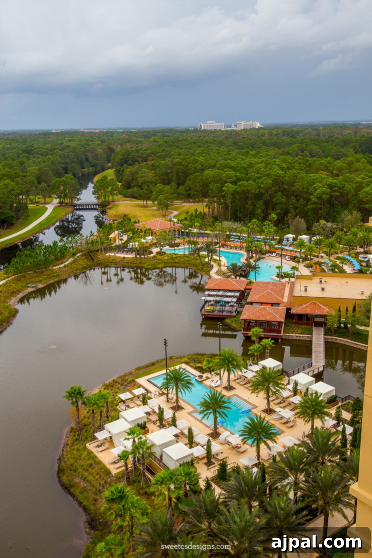 Four Seasons Orlando at Disney World A Magical Getaway 4 Aerial view of the Four Seasons Orlando resort showcasing luxurious pool areas and tranquil pond