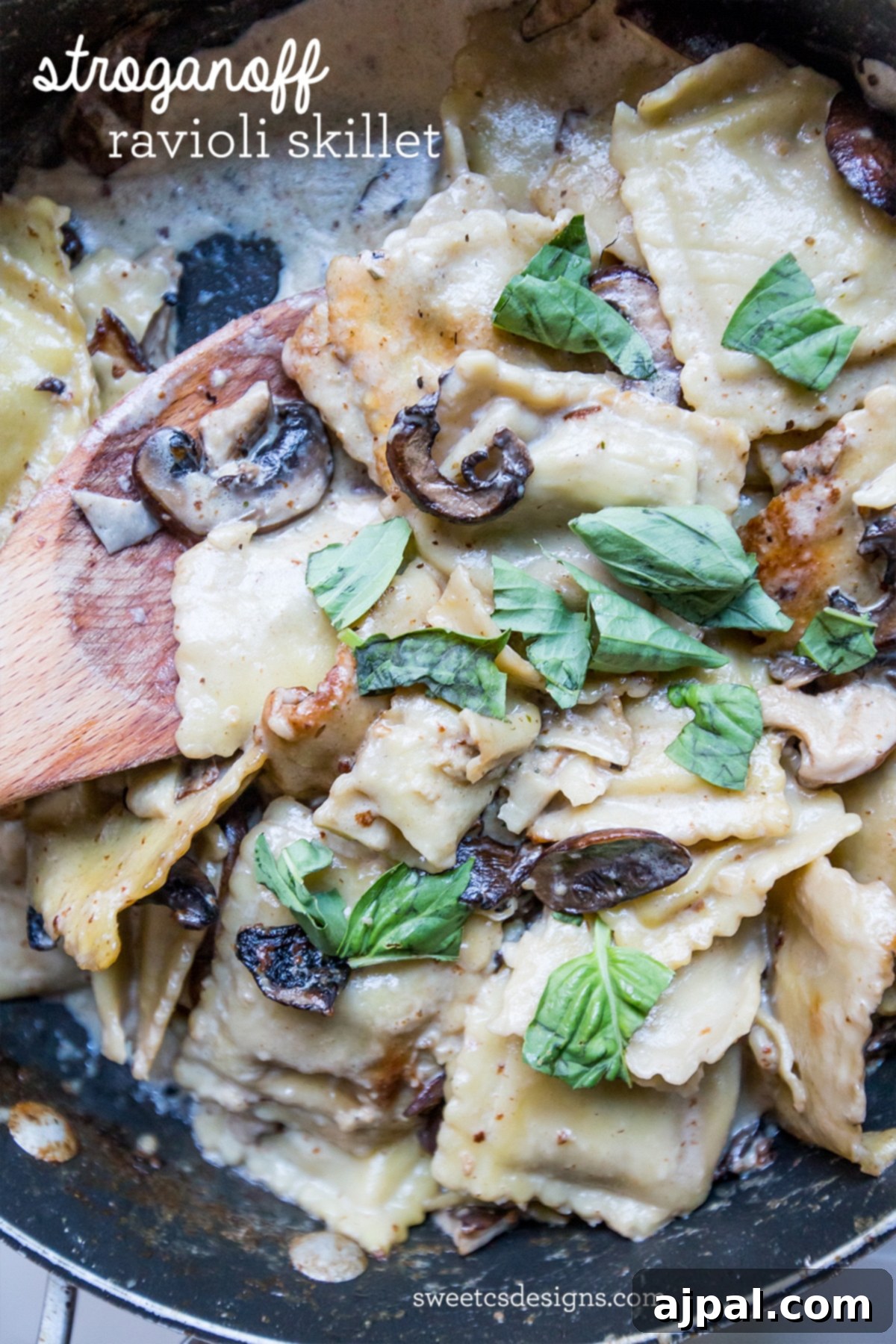 Close-up of One-Pot Skillet Ravioli Stroganoff with beef ravioli, mushrooms, and fresh basil.