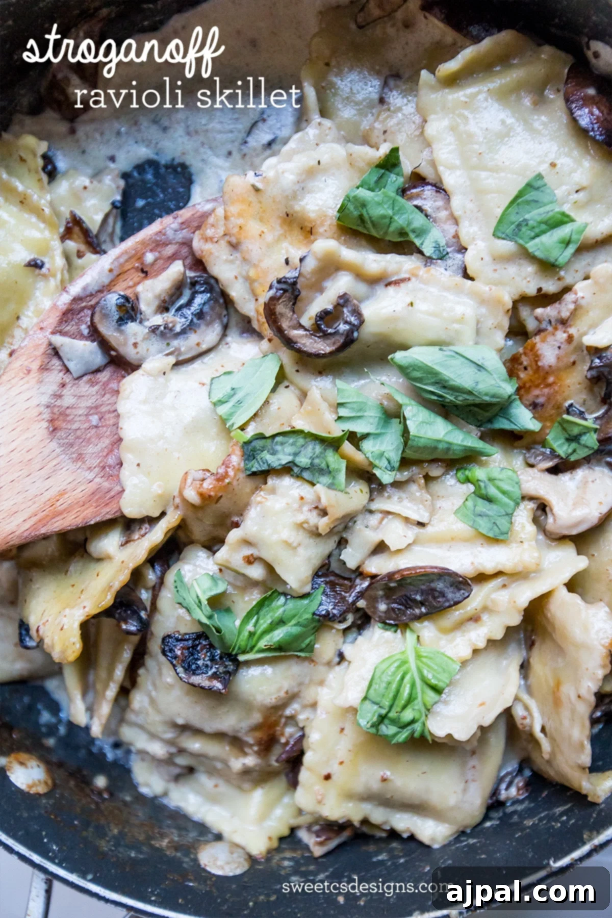 Close-up of a creamy beef ravioli skillet with mushrooms and fresh basil