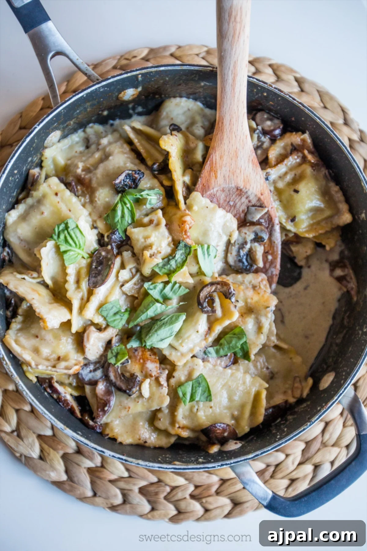 Cooking Skillet Ravioli Stroganoff in a pan with a wooden spoon