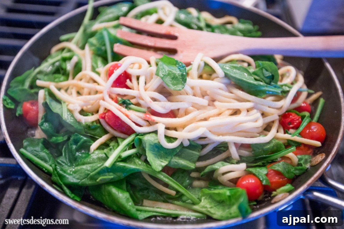 Creamy one-pot Alfredo pasta skillet with spinach, looking easy to make and delicious.