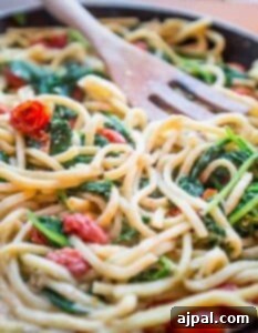 Creative one pot garden Alfredo pasta skillet with spinach and tomatoes.