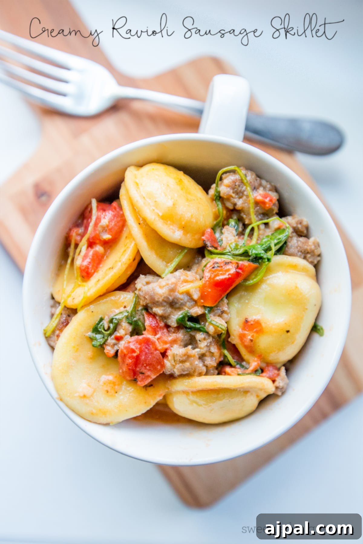 One pot creamy ravioli and sausage skillet with arugula, a delicious and easy meal.