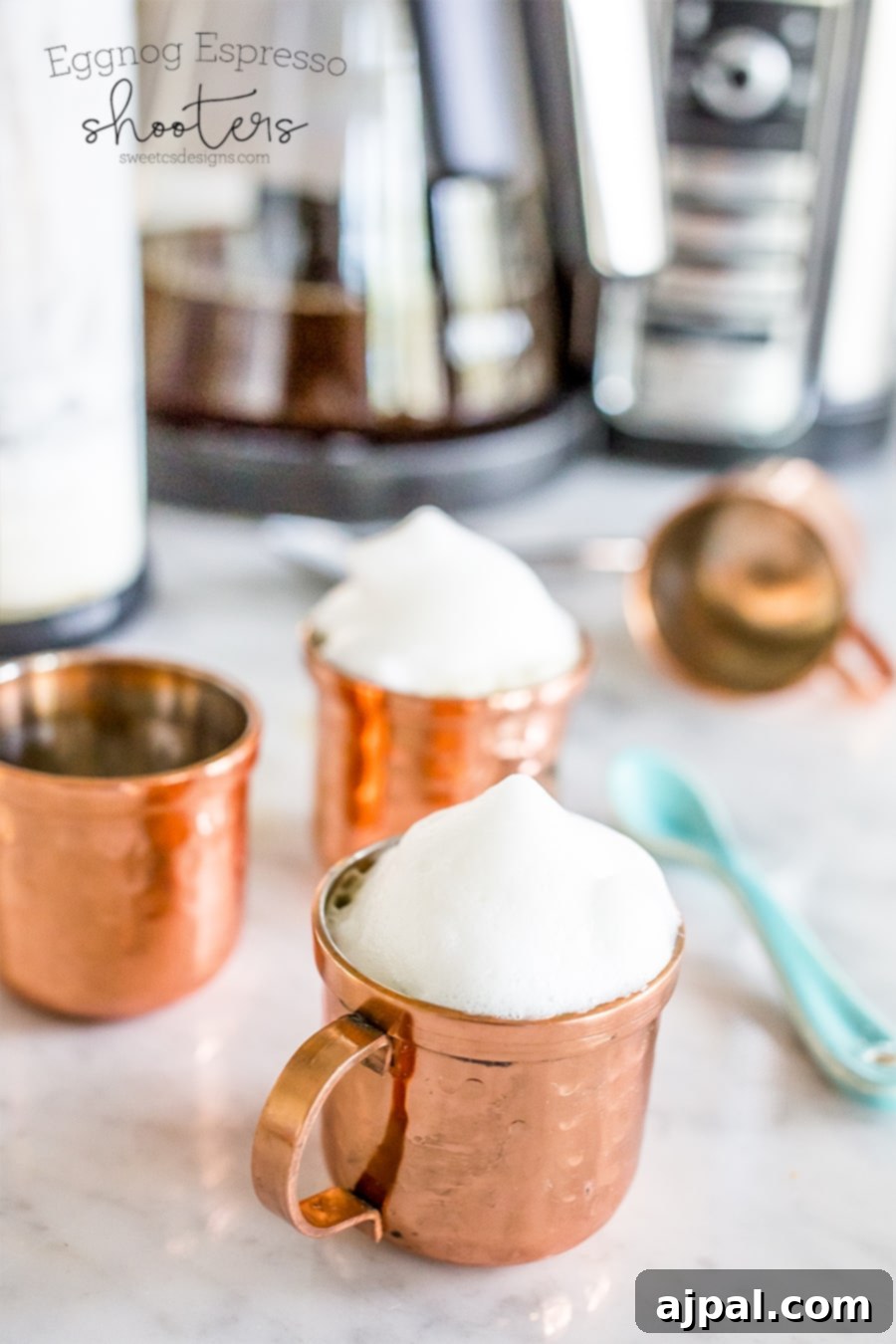 Festive Espresso Eggnog Shots 4 Two copper small mugs with milk foam, showcasing eggnog espresso shooters for a festive party