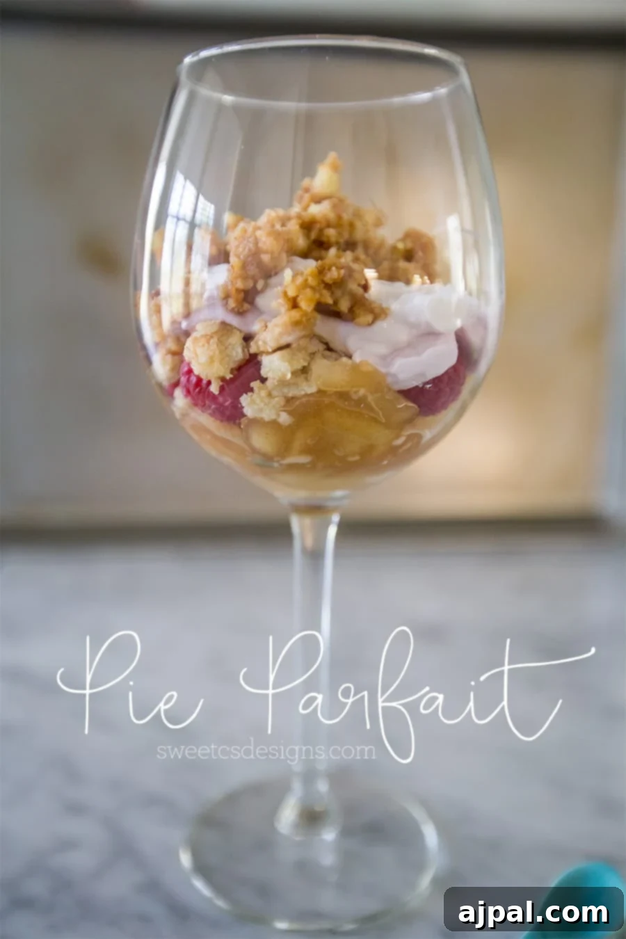 Upcycled Pie Parfaits 5 An inviting close-up of a layered leftover pie parfait in a elegant glass. The distinct layers of creamy yogurt, sweet fruit filling, and crunchy topping are perfectly showcased, promising a delightful culinary experience.
