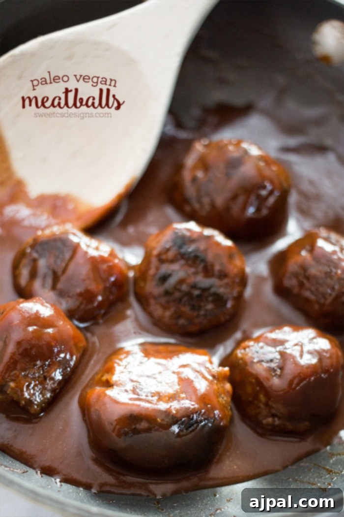 Smoky Vegan Paleo BBQ Meatballs 4 Flavorful paleo vegan meatballs simmering in a rich BBQ sauce within a pot, ready to be served.