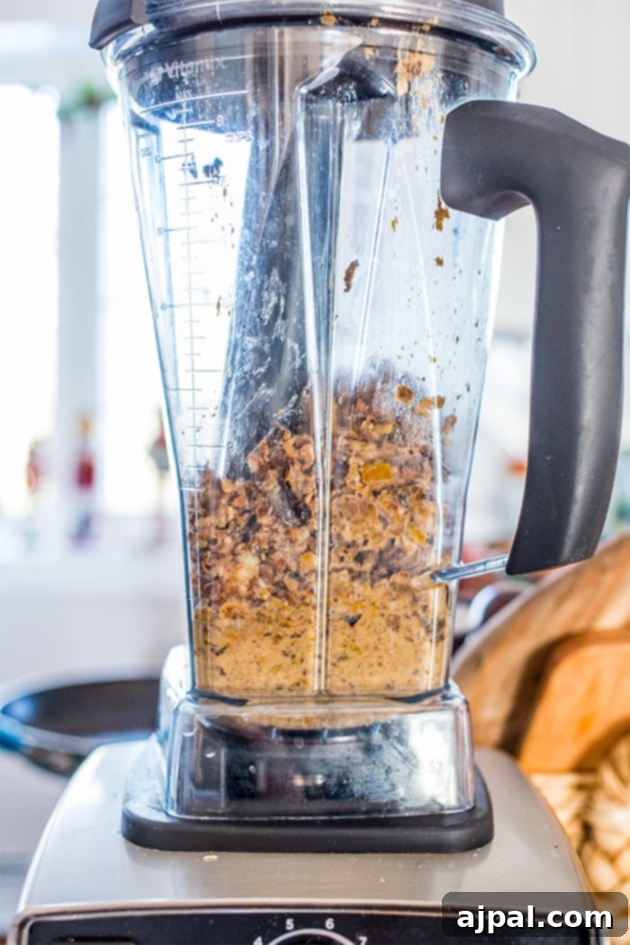 Smoky Vegan Paleo BBQ Meatballs 5 Ingredients being blended in a high-performance Vitamix blender, perfect for creating smooth textures in vegan recipes.