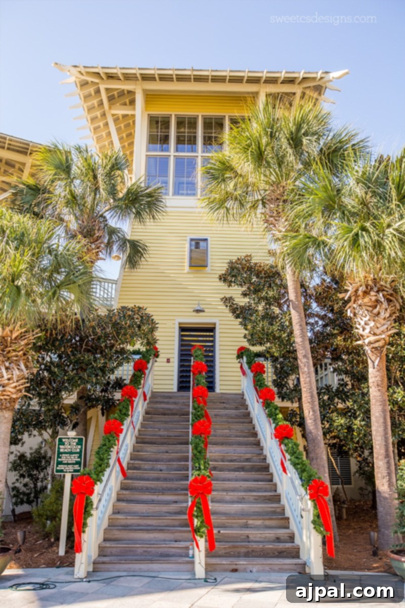 Yuletide in Paradise Seaside Florida 4 A festive Watercolor resort building at Christmas, featuring a grand staircase and holiday decor.