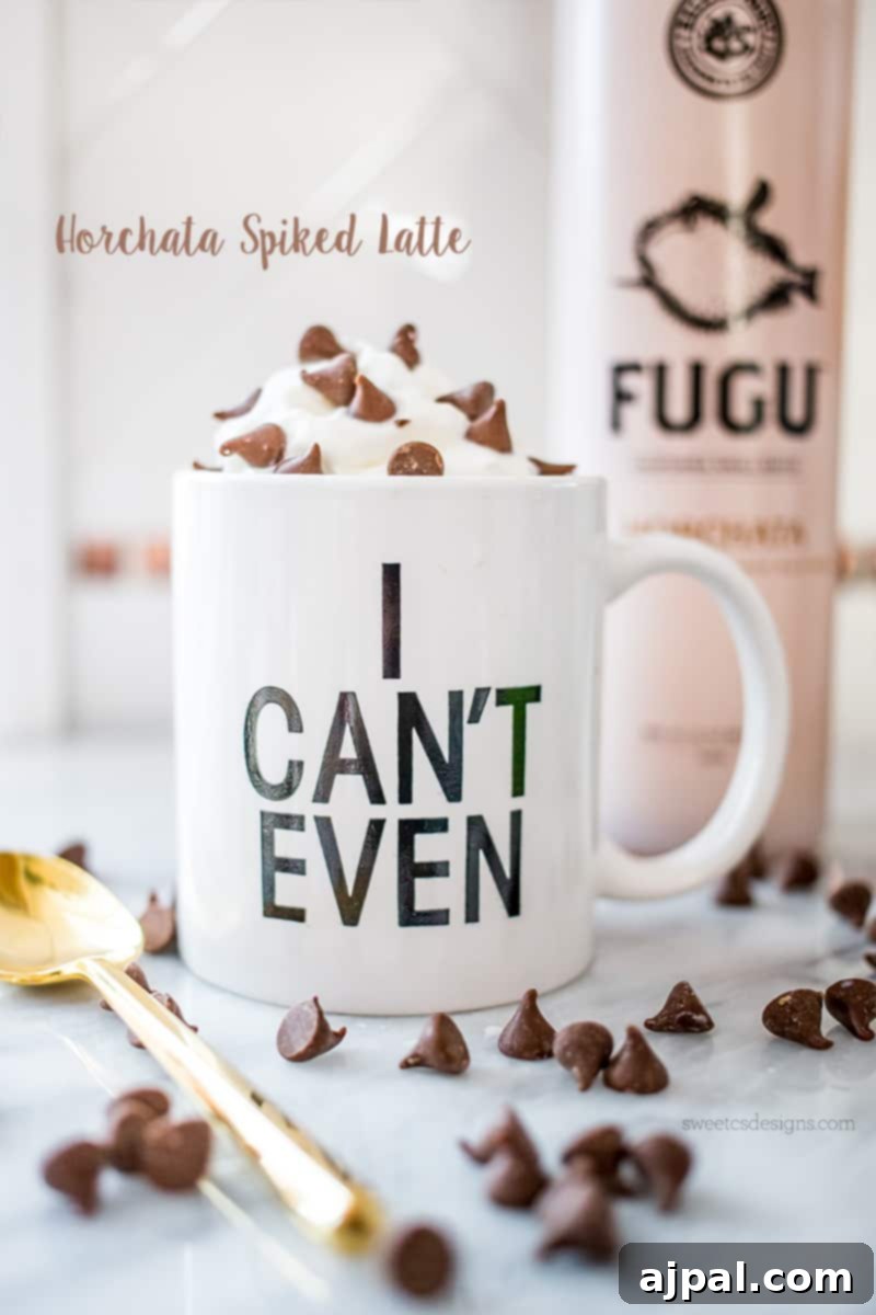Spirited Horchata Delight 2 A festive Horchata Spiked Latte in an 'I Can't Even' mug, topped with whipped cream, chocolate chips, and a golden spoon.