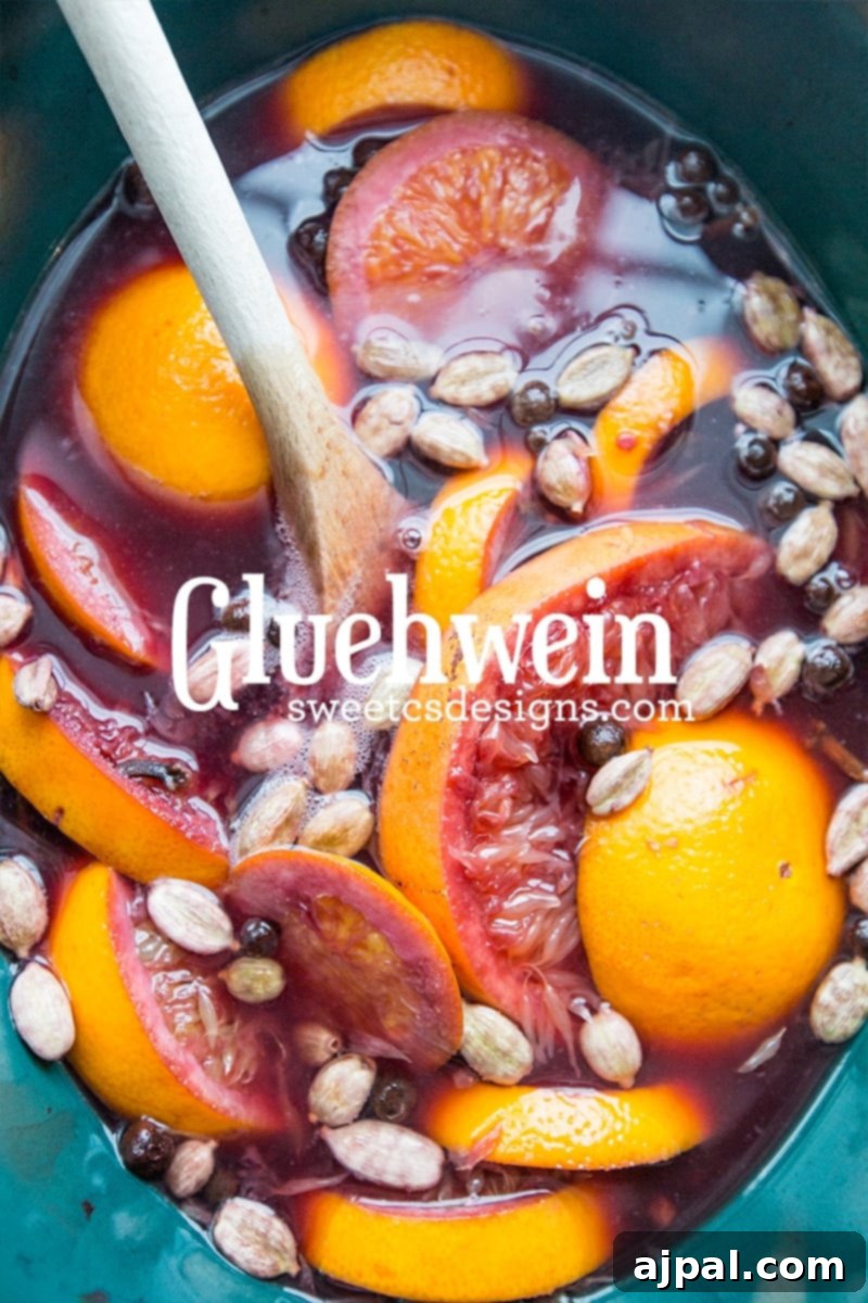 Spiced Winter Warmer 7 A warm and inviting crock pot filled with homemade Glühwein, garnished with fresh orange slices, whole cloves, and cardamom, ready for a cozy holiday celebration.