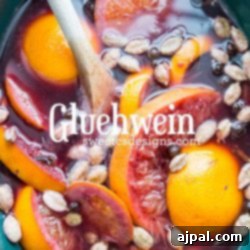 A bowl of fruit and nuts served alongside a spiced hot wine recipe.