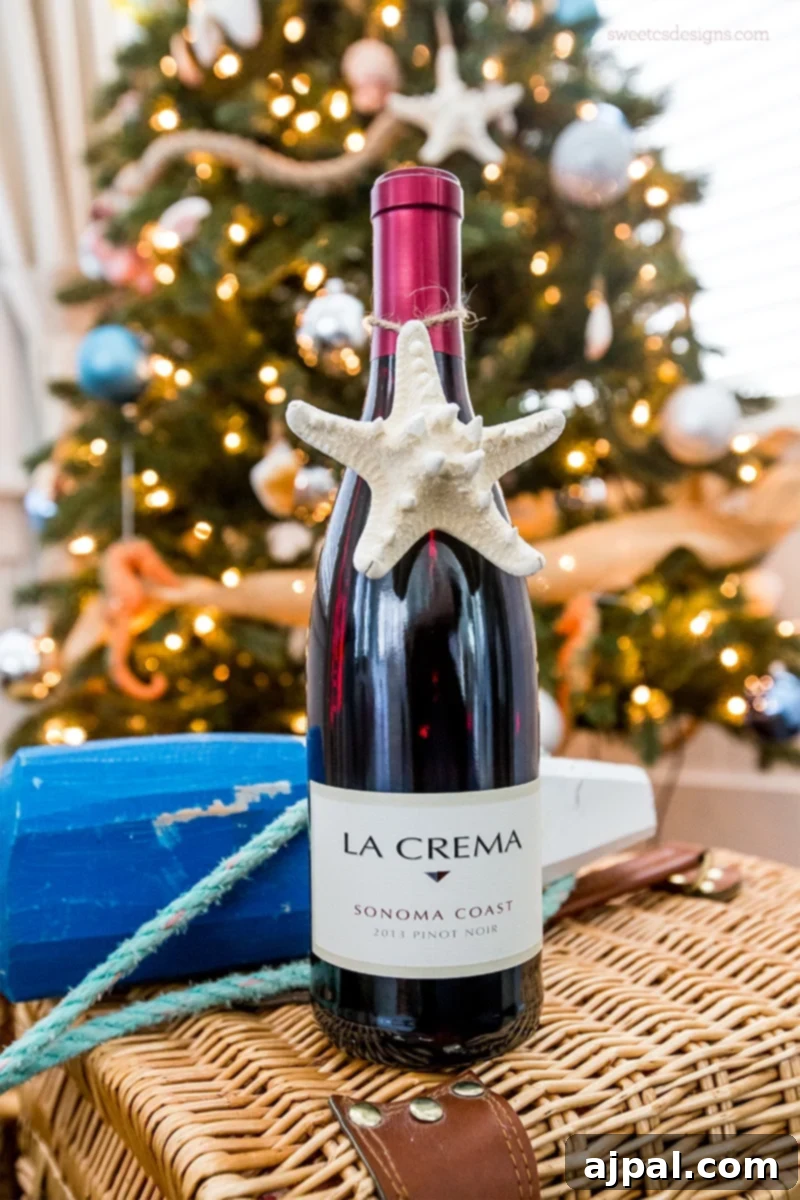 Easy Seashell Tree Decorations for a Coastal Vibe 2 Charming starfish and seashell ornaments adorning a beach-themed Christmas tree, complemented by a rustic wine bottle on a wicker basket.