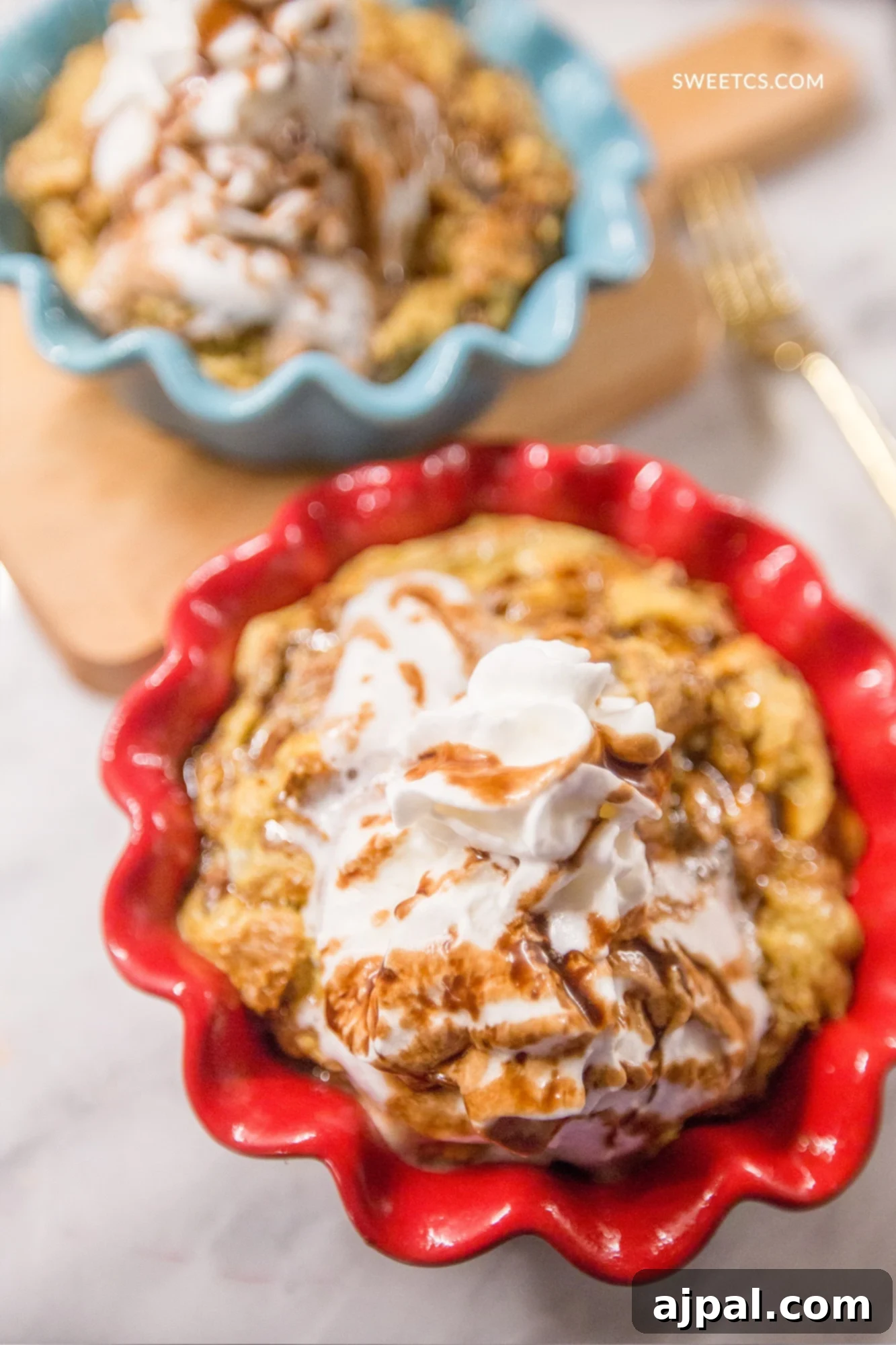 Coffee-Infused Bread Pudding 7 Two individual servings of coffee-soaked bread pudding, each elegantly topped with whipped cream, demonstrating the versatility of this dessert for personalized presentation.