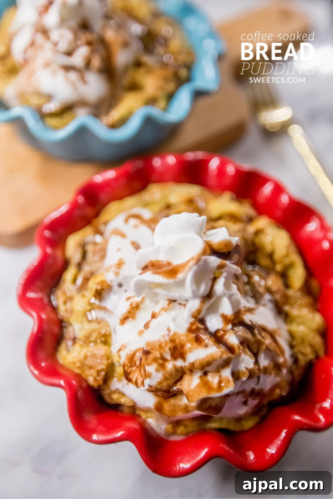 Coffee-Infused Bread Pudding 3 Two servings of coffee soaked bread pudding, each generously topped with whipped cream, hinting at a delightful secret ingredient that makes it extra special.