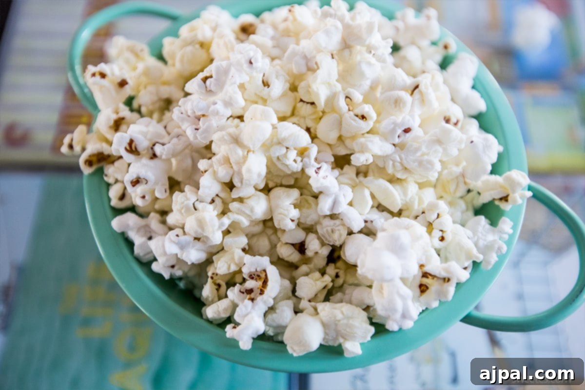 Movie Theater Popcorn Perfection at Home 5 A bowl of homemade movie style butter popcorn sitting on a table, perfectly prepared for a cozy evening.