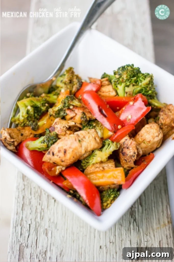 chicken with peppers and broccoli in a bowl with sauce