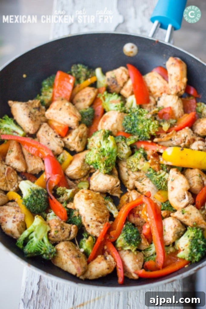 chicken with peppers and broccoli in a bowl with sauce