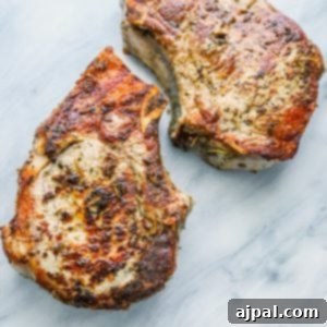 Succulent Herbs de Provence pork chops, seared to a perfect golden brown, ready to be served as a main dish.