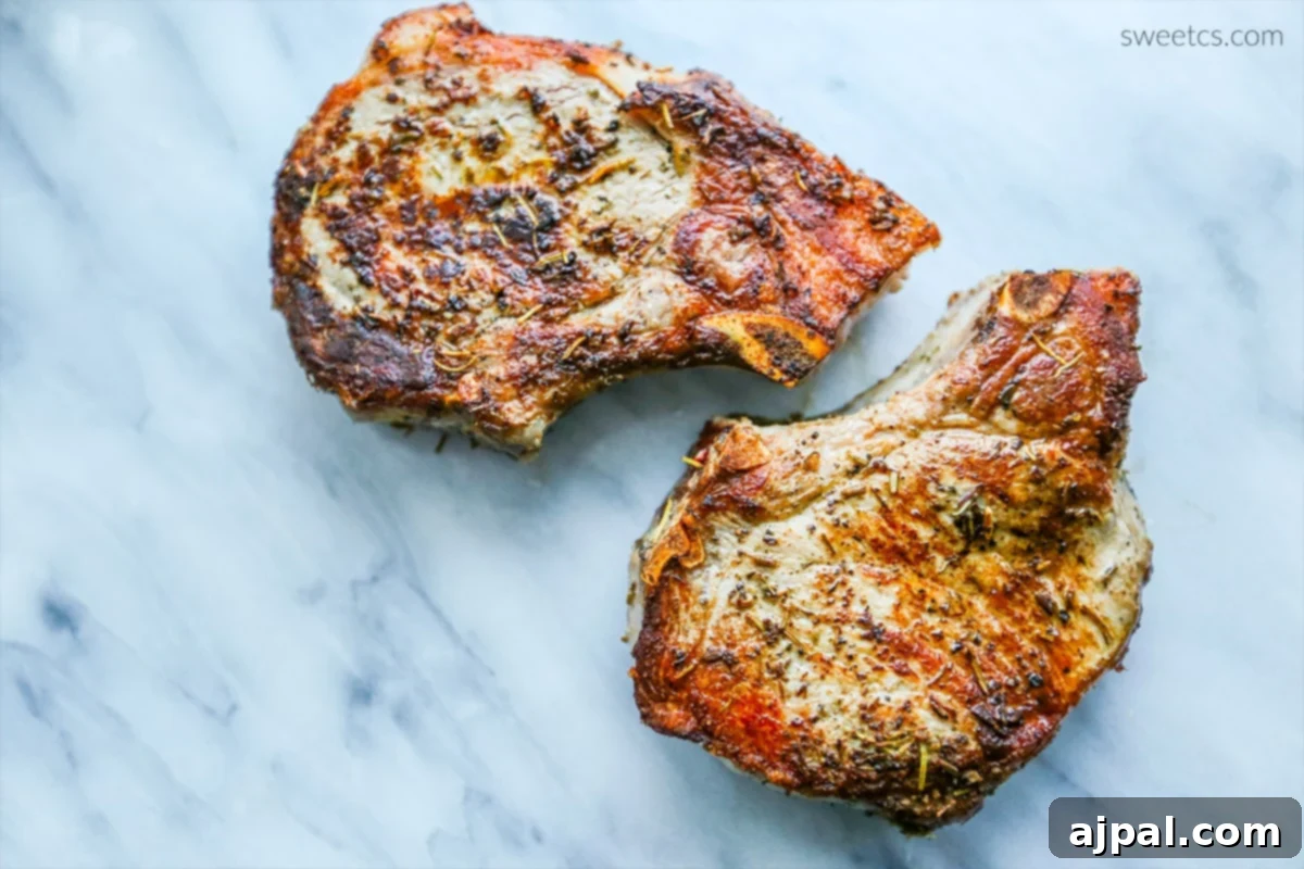 The ultimate method for achieving perfect, juicy pork chops every time, with a close-up of the golden-brown crust.