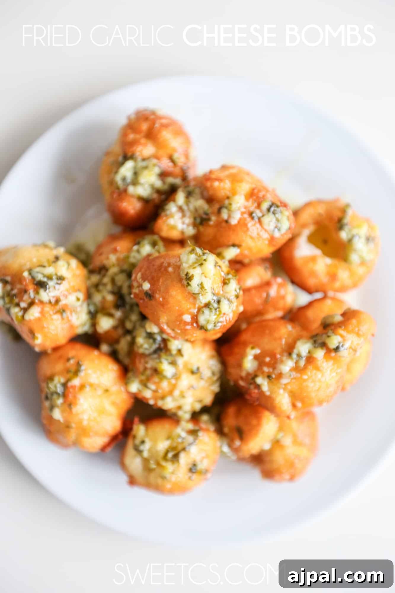 Crispy Garlic Cheese Blasts 2 Fried garlic cheese bombs, golden and delicious, on a serving plate.