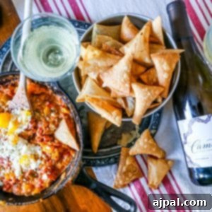 cheesy pepper dip on a table with homemade chips